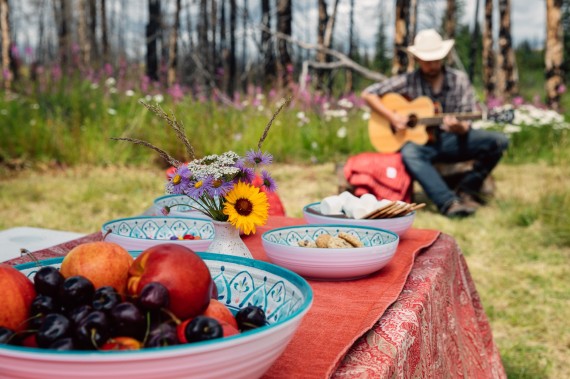 Picnic lunch is served in a clearing by the river bank.