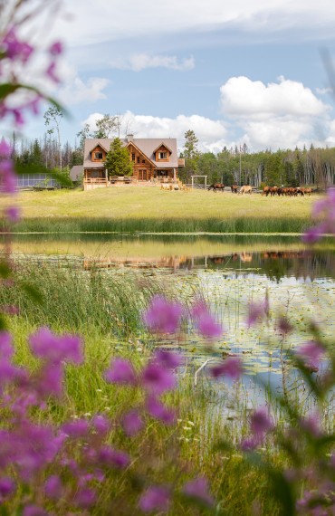 The main Ranch House and its Siwash Suite, amid a lush, verdant oasis at Siwash Lake
